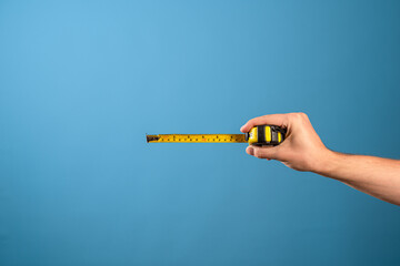 Measure it, a yellow construction tape measure to measure the length of something. Roulette with a...