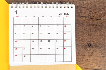 January 2022 desk calendar on wooden background.