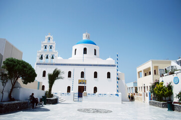 GREECE, SANTORINI: Scenic seaside landscape view of white classics buildings on the rocky slopes of Thira island  