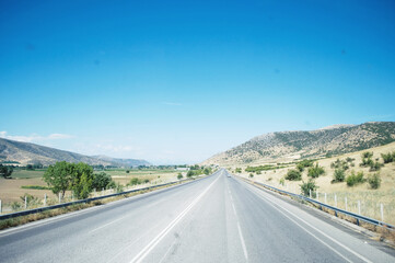 Fototapeta premium GREECE: Scenic landscape view with the road and mountains in the background 