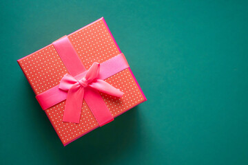 Red gift boxe on green background. Concept of holiday