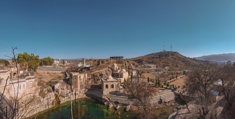 Fototapeta na wymiar Choa SaidanShah, Chakwal, Pakistan - December, 29, 2019: Shri Katas Raj is a complex of several Hindu temples and a pond named Katas which is sacred to Hindus. The site is almost 5000 years old!