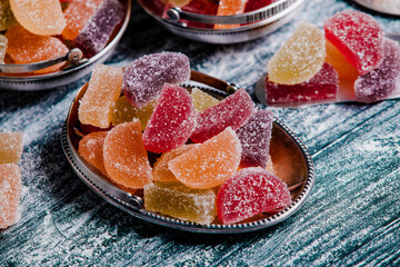 Dessert marmalade in the form of lemon and orange slices. The sweetness of jelly candy.