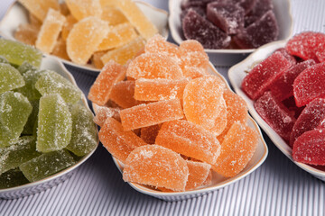 Dessert marmalade in the form of lemon and orange slices. The sweetness of jelly candy.