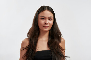 Headshot portrait of young Asian woman on white background