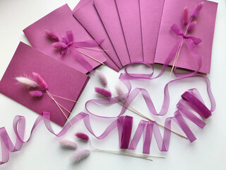 Making greeting cards. Paper blanks, ribbons and lagurus branches. Are laid out on the table surface.