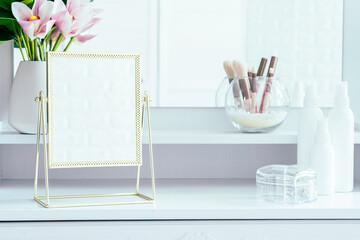 Table mirror on dressing table with make up accessories. Self-Care. White, pastel interior