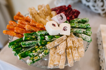 Eastern sweets. Assorted traditional Turkish delight with different nuts, coconut shavings, pistachios nuts and powdered sugar. Top view. Arab dessert, rahat lokum, sherbet, nougat. Flat lay.