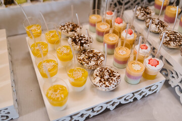 Candy bar. Delicious wedding reception on dessert table. Festive table with sweets, candies, desserts, tartlet and cupcakes. Top view. Close up.