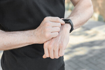 Photo of male hands touching screen generic design smart watch. Horizontal