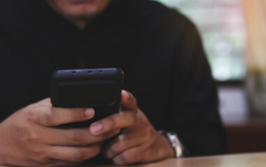 Hands of man using online virtual app on mobile phone. Millennial guy chatting on smartphone, using banking services, reading text message, typing, shopping, making call, browsing internet. Close up