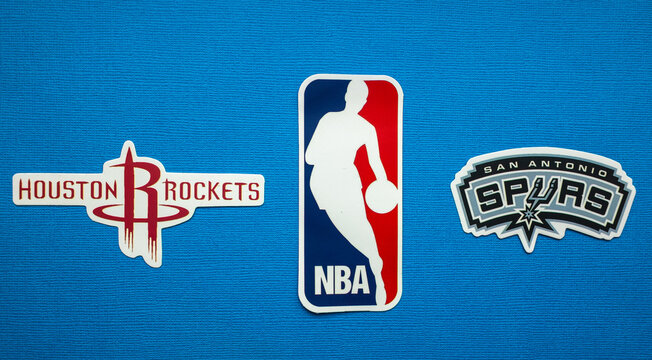 October 1, 2021, Springfield, USA, Emblems Of The Houston Rockets And San Antonio Spurs Basketball Teams On A Blue Background.