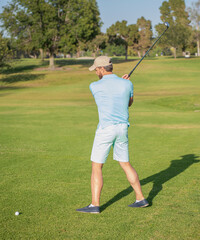 professional sport outdoor. back view. male golf player on professional golf course.