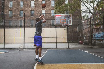 Fototapeta na wymiar Basketball player training on a court in New york city