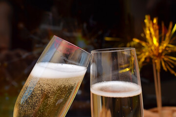 two glasses with champagne clink glasses close up