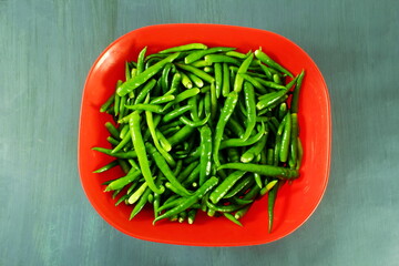 garden fresh green chilli or chili pepper in basket 