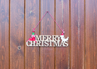 Decorative Merry Christmas ornament on a rustic wooden background with copy space