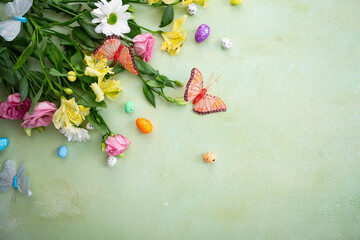Fototapeta na wymiar Easter background with flowers and copy space green surface