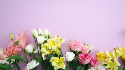 Overhead view of flowers on light pink surface spring concept