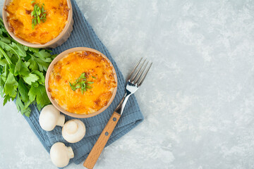 Casserole with cheese, sauce and mushrooms. French dish julienne. European cuisine. Flat lay. Copy space.