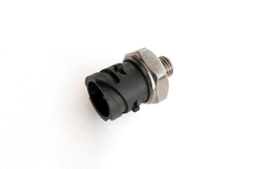 Oil pressure sensor of car isolated on white background. New spare parts.