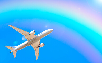 Fototapeta na wymiar 飛行機と虹と青空｜旅行・全国旅行支援・GOTOトラベルキャンペーンのイメージ素材