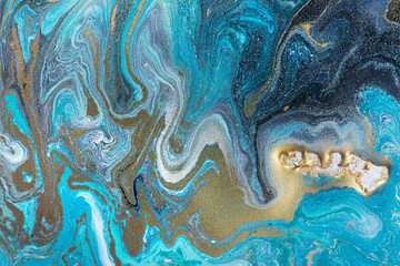 Streams of liquid blue, white and gold ink curls. Waves of fluid turquoise and golden fluid paint.