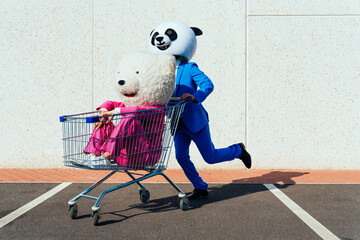Storytelling image of a couple wearing giant panda head