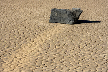 Large Block of Stone Sits At The End of Its Path Through The Mud