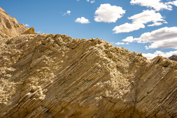Layers of Stone On A Golden Canyon Hillside