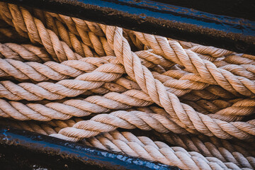 Close-up of ropes laying coiled up on board a steel ship