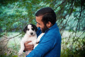 Naklejka na ściany i meble indian street dog puppy images with man