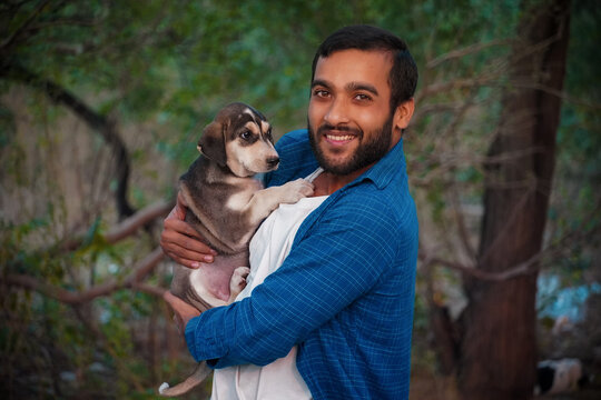 man with indian street dog