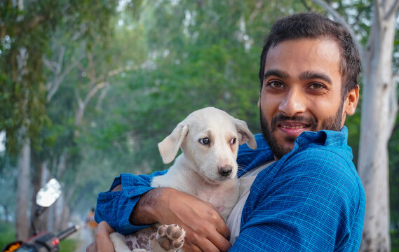 man with adorable street dog image - cute indian street dog images with man