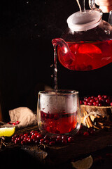 teapot and cup with cranberries tea