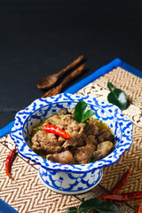 Food concept homemade Thai green curry in Thai classic ceramic Pedestal plate with copy space