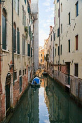 Naklejka na ściany i meble Venice, Italy - 10.12.2021: Traditional canal street with gondolas and boats in Venice, Italy.
