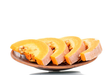 Several slices of sweet organic pumpkin on a clay plate, close-up, isolated on white.