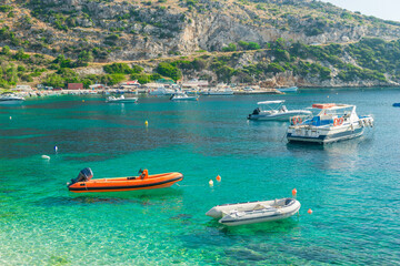 Fototapeta na wymiar boats sway on the turquoise waves of the Ionian sea of Greece in sunny weather