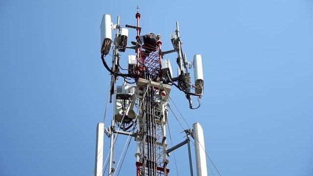 workers are working at 5g antenna tower for maintaining.serves cellular antenna, technician worker repair telecommunication tower on sunlight at background.	