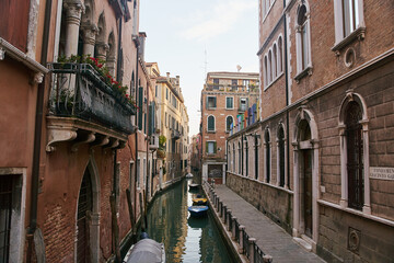 Obraz na płótnie Canvas Venice, Italy - 10.12.2021: Traditional canal street with gondolas and boats in Venice, Italy.