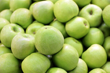 Green apples close up for background. Fresh harvest, ripe fruits on farm market