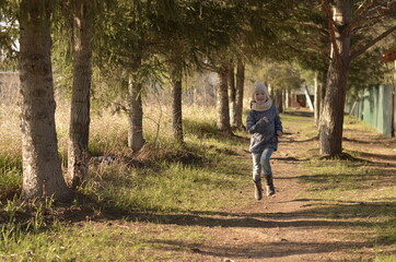 a girl runs through the forest