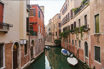 Venice, Italy - 10.12.2021: Traditional canal street with gondolas and boats in Venice, Italy.