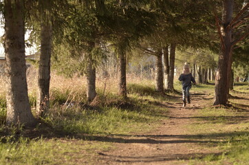 a girl runs through the forest