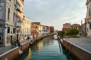 Venice, Italy - 10.12.2021: Traditional canal street with gondolas and boats in Venice, Italy.