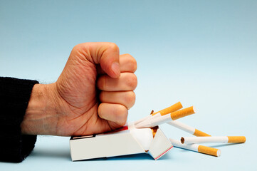 crushing a pack of cigarettes, stop smoking concept