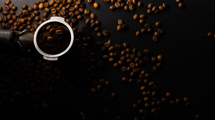 Coffee beans in the coffee horn on the background of coffee beans