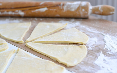 rolling pin and dough on a wooden kitchen table