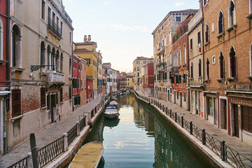 Venice, Italy - 10.12.2021: Traditional canal street with gondolas and boats in Venice, Italy.